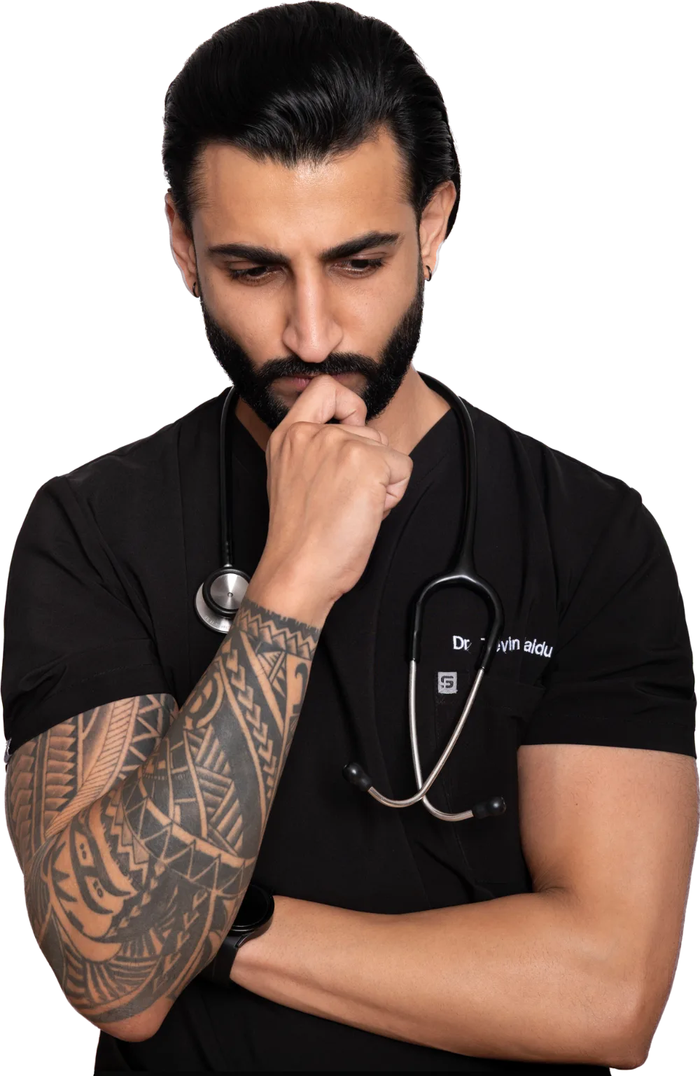 Dr Tevin Naidu in black scrubs with a stethoscope, head bowed in thought, one hand at his chin and his arms crossed