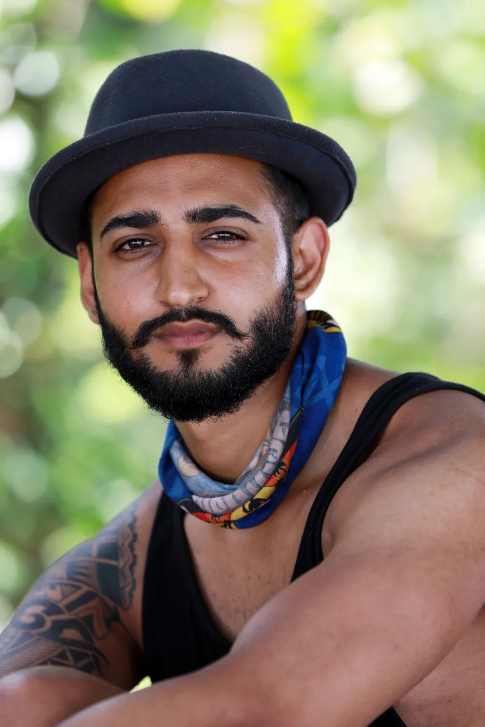 Dr Tevin Naidu in a black hat and a blue Mindanao buff during Survivor South Africa: Philippines, 2018